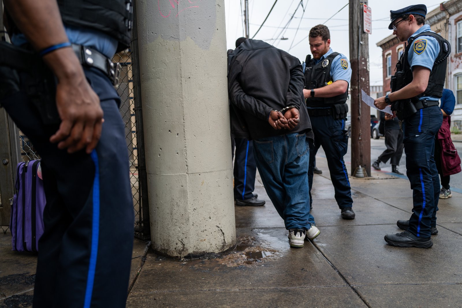 Police arrest a man as the city of Philadelphia begins a clearing of a drug encampment in the Kensington section of Philadelphia on May 8, 2024.
