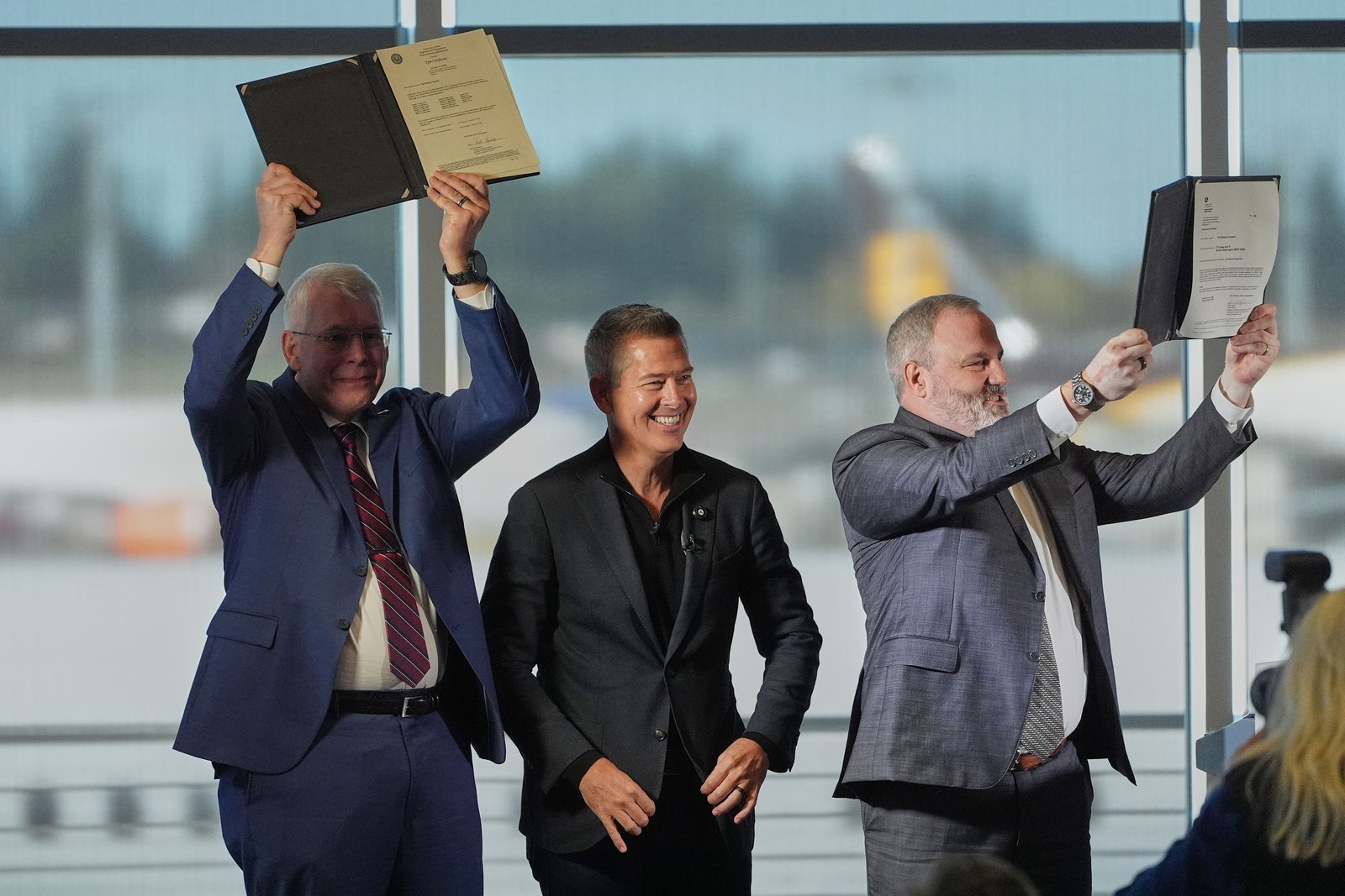 U.S. Transportation Secretary Sean Duffy, center, reacts while presenting the certification of Boeing