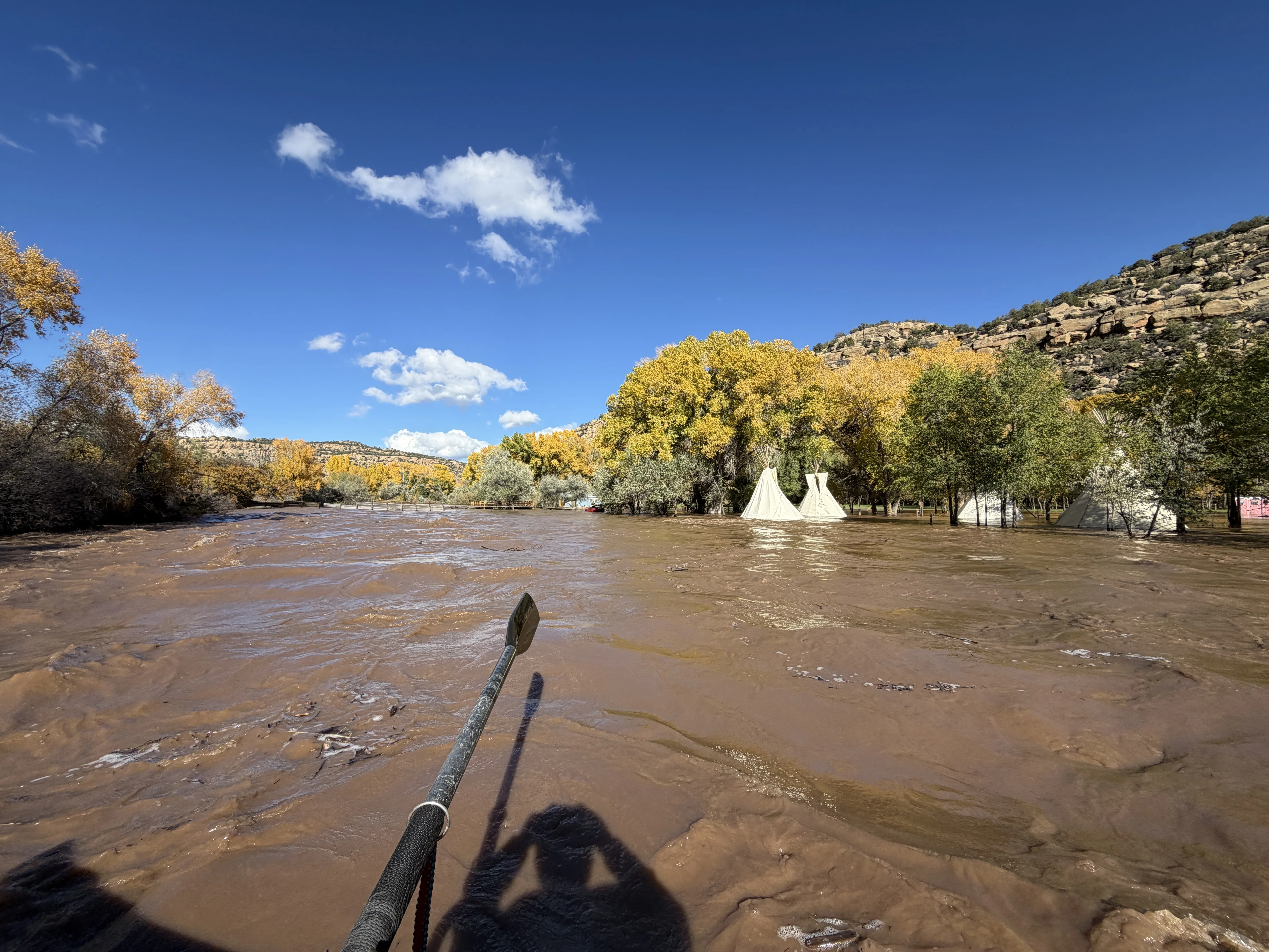 Aaron Schenk rafted down the flooded Animas River in southwestern Colorado  on Friday. He passed by an inundated event space.