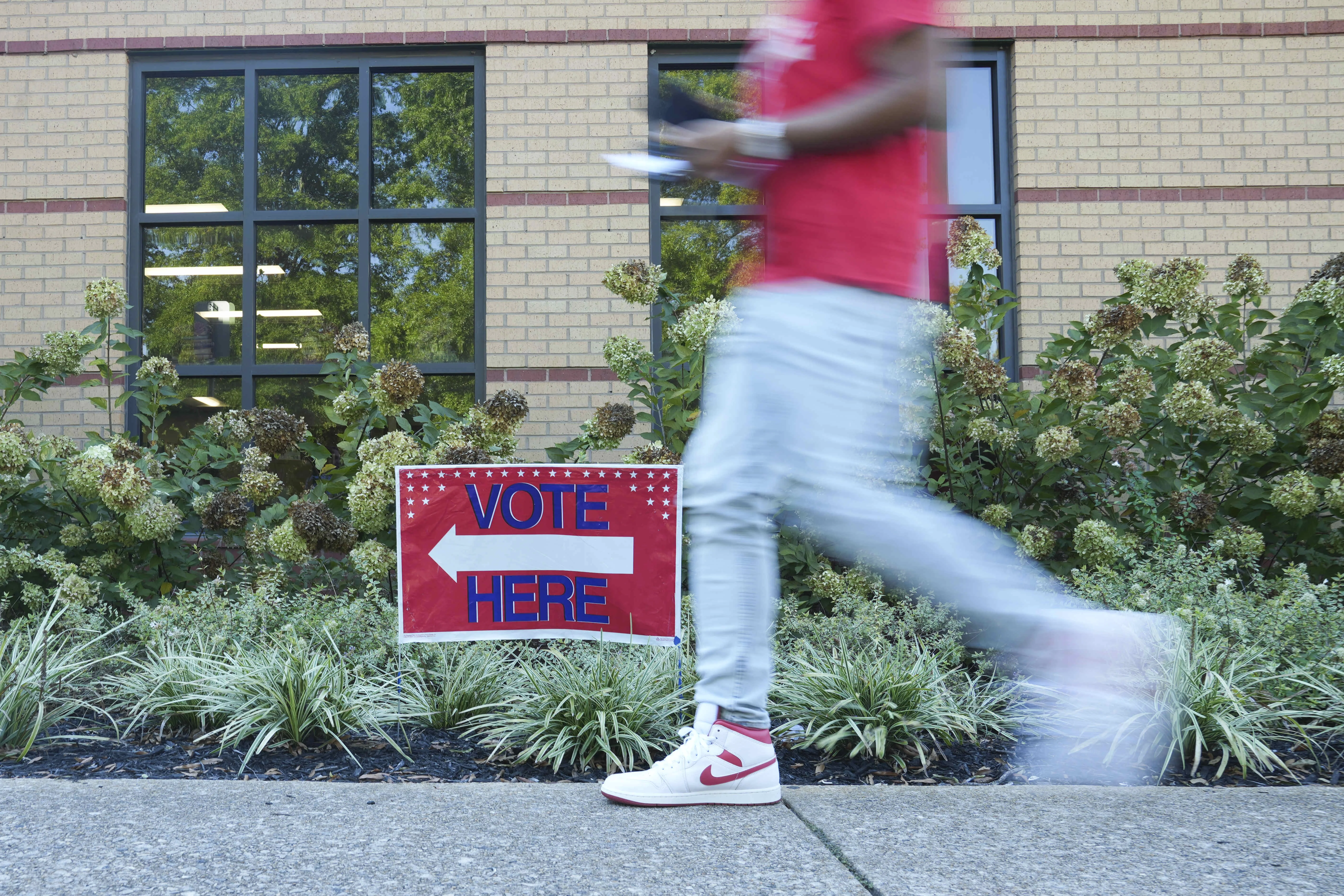 A person walks past a voting sign at the East Point Library on the first day of early voting on October 13, 2026 in Atlanta, Georgia. Early voting will run from October 13th- 30th with Election Day taking place on November 3rd.