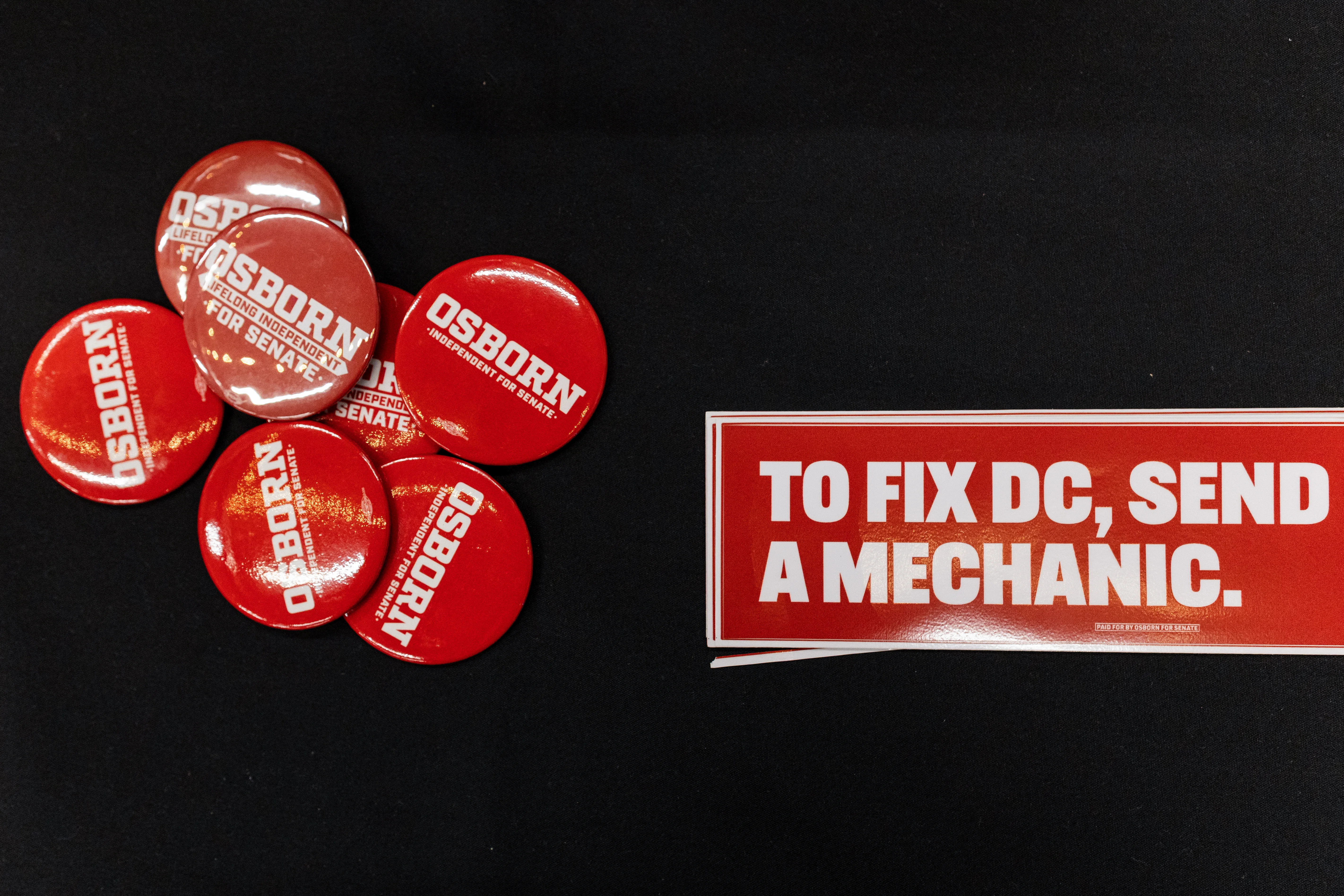 Pins and bumper stickers supporting Dan Osborn