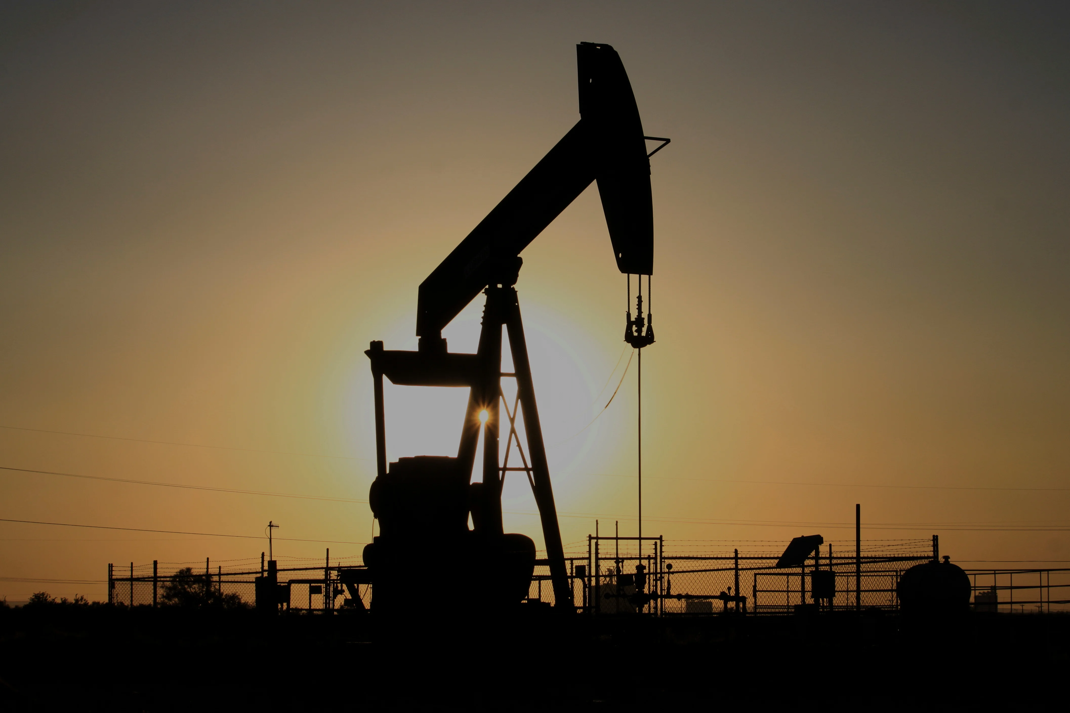A pump jack operates at sunset in the Permian Basin near Loving, N.M., on Tuesday, May 20, 2025.
