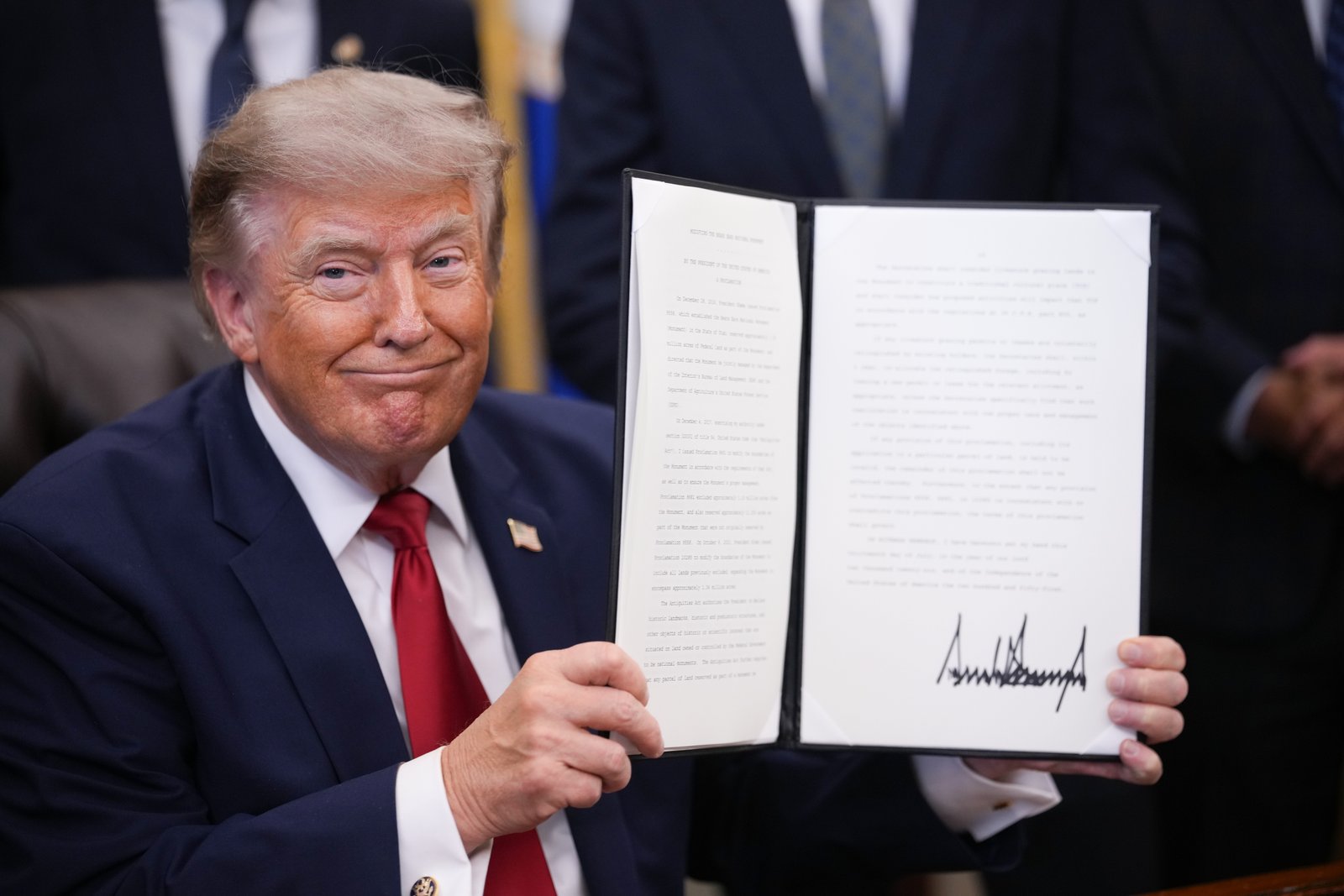 In this file photo from July 2026, President Trump shows off an executive order he signed in the Oval Office of the White House.