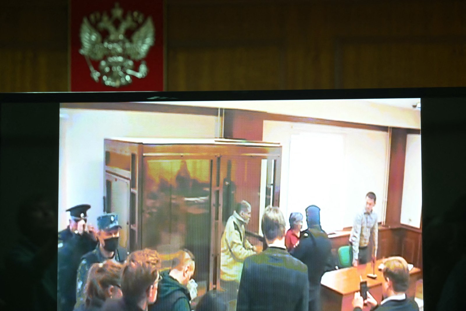 A screen set up at a hall of the Moscow City Court broadcasts the verdict in the trial of U.S. citizen Stephen Hubbard, accused of fighting as a mercenary for Ukraine, in Moscow on Oct. 7, 2024.
