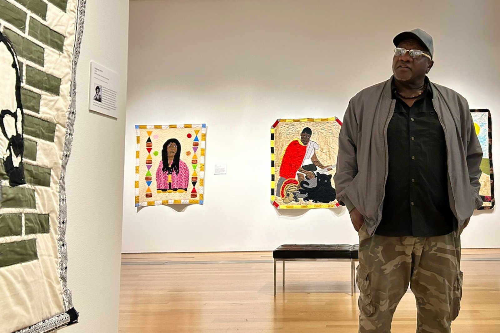 Gary Tyler speaks about his work at the Grand Rapids Art Museum in Michigan. Behind Tyler are his quilts <em>Big Toe</em>, (2024) and <em>Enduring</em>, (2025). They feature two individuals who are incarcerated. He hopes his work draws attention to their plight and humanity.’/></p>
<p>A quilt artist who spent decades on death row now has his first solo exhibit at the Grand Rapids Art Museum. </p>
<p>(Image credit: Sea Stachura for NPR)</p>
<p><img src=