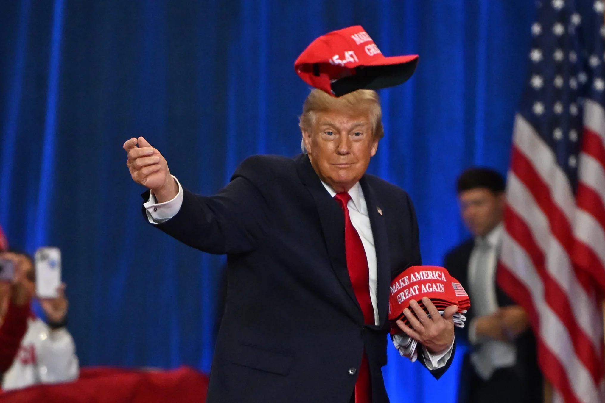 President Donald Trump throws a hat into the crowd as he arrives at a campaign rally at Lubbock Memorial Civic Center, Tuesday, Oct. 27, 2026, in Lubbock, Texas.