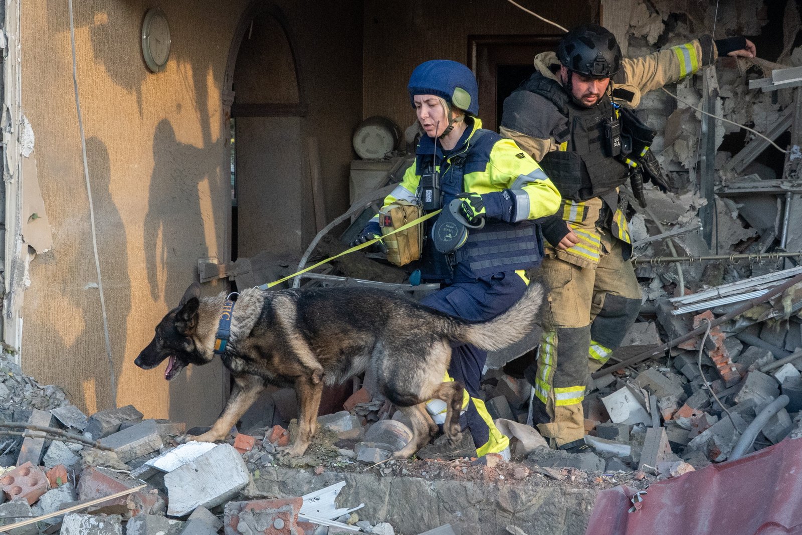 Rescuers with a search dog look for victims among the rubble of a house after a Russian air attack in Kharkiv, Ukraine, Tuesday, Oct. 20, 2026.