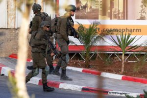 Israel orders sweeping West Bank operation after military says 2 soldiers were killed in attack that left 2 gunmen dead